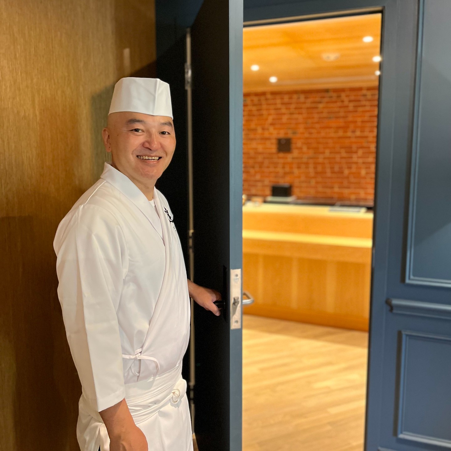 Chef Tatsuya Sekiguchi at the entrance of his restaurant, Tatsu Dallas.