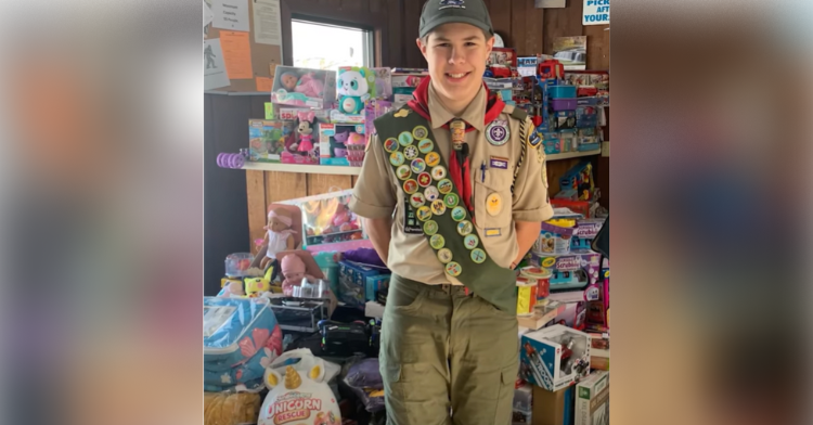 Jonathan Werner wears his Boy Scouts uniform and poses with gifts he purchased for other kids.