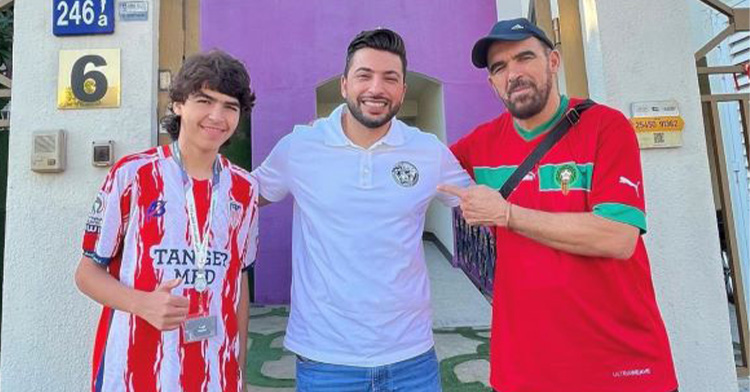 Three men standing in front of a dental clinic smiling, including Mohammed and Shadi Alshaikh.