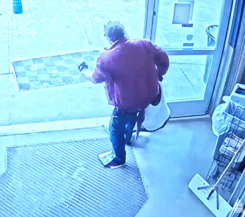 Store's camera footage of a man wearing boxes on his feet instead of shoes.