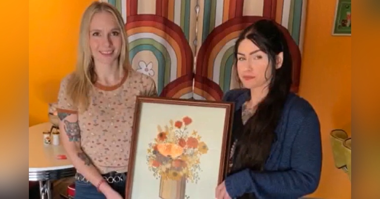 Annie Cunningham and Ryleigh Gleason holding heirloom cross stich