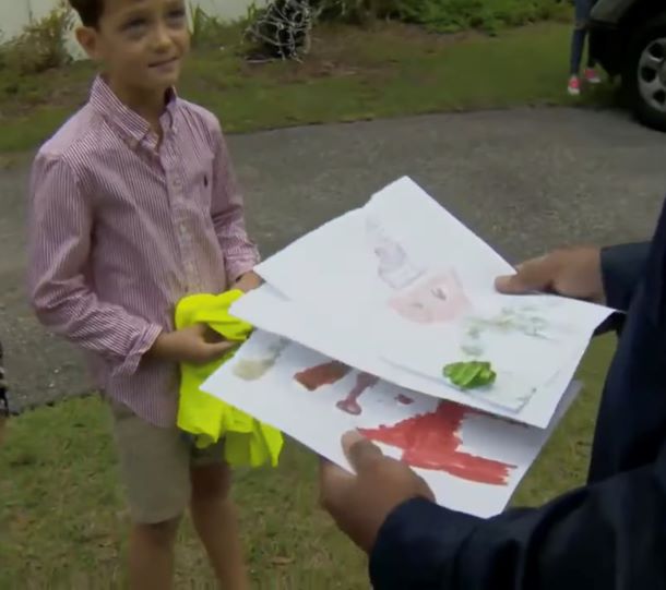 Axel is showing his artwork to Tony.