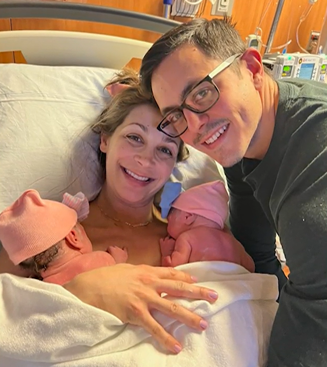 Shelly Battista smiles with her husband and newborn daughters