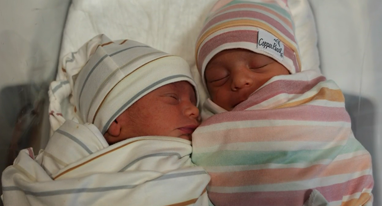 Battista twins bundled up in the hospital after birth.