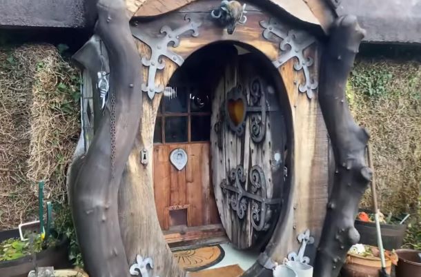 The round front door to a renovated cottage.
