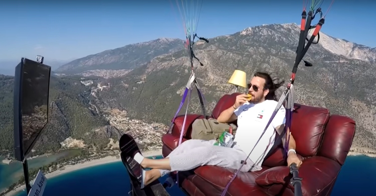 Hasan Kaval paragliding on a couch