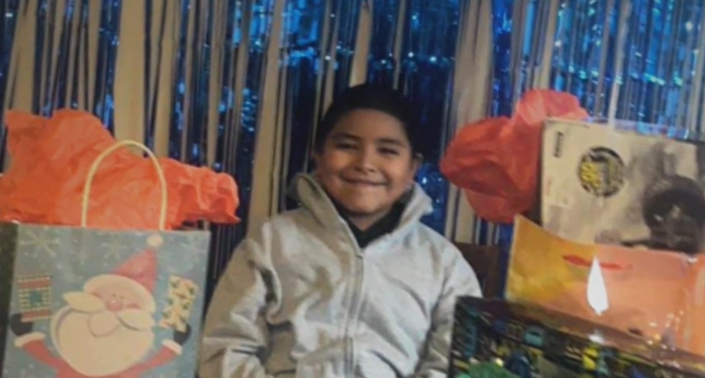 Jaydenn Lopez smiling with his birthday gifts.
