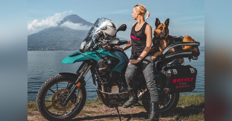 Jess Stone on motorcycle with Moxie the dog