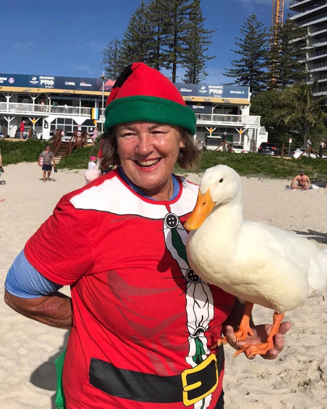 Kate Miller wearing a Santa hat and holding Duck.