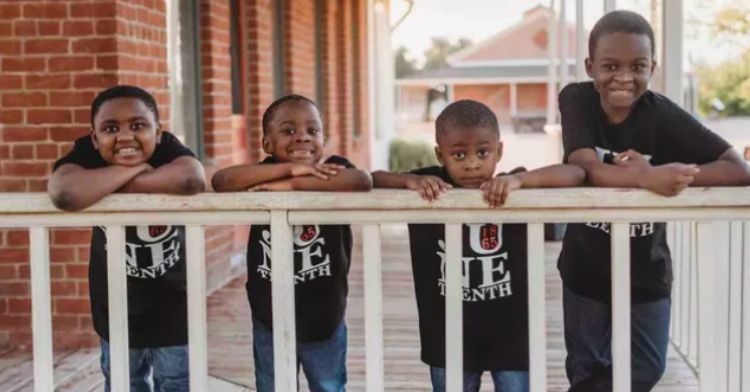 Kayla Howard's four sons standing with faces resting on porch railing