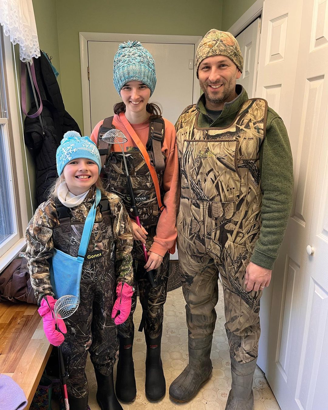 Molly Sampson with her sister Natalie and father Bruce, dressed in hunting gear to go fossil hunting.