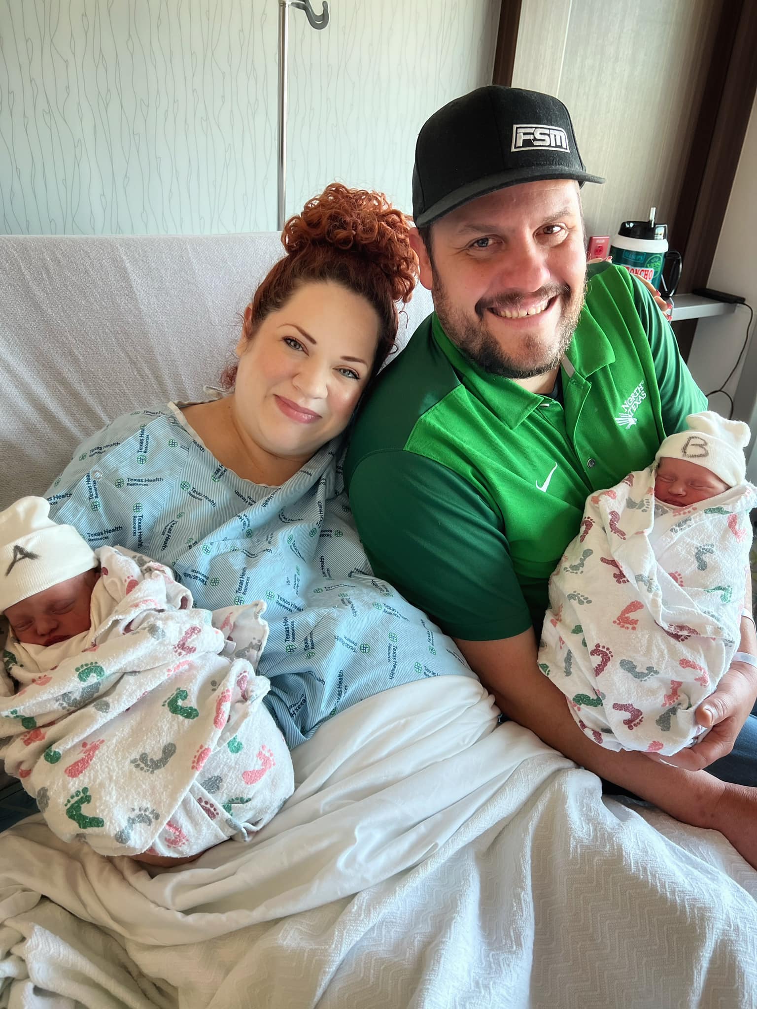 Kali Jo and Cliff Scott holding their newborn twins in the hospital.
