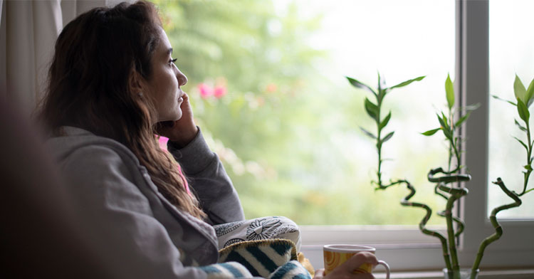 woman looking out window