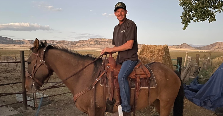 Shane smiling big as he rides Mongo.