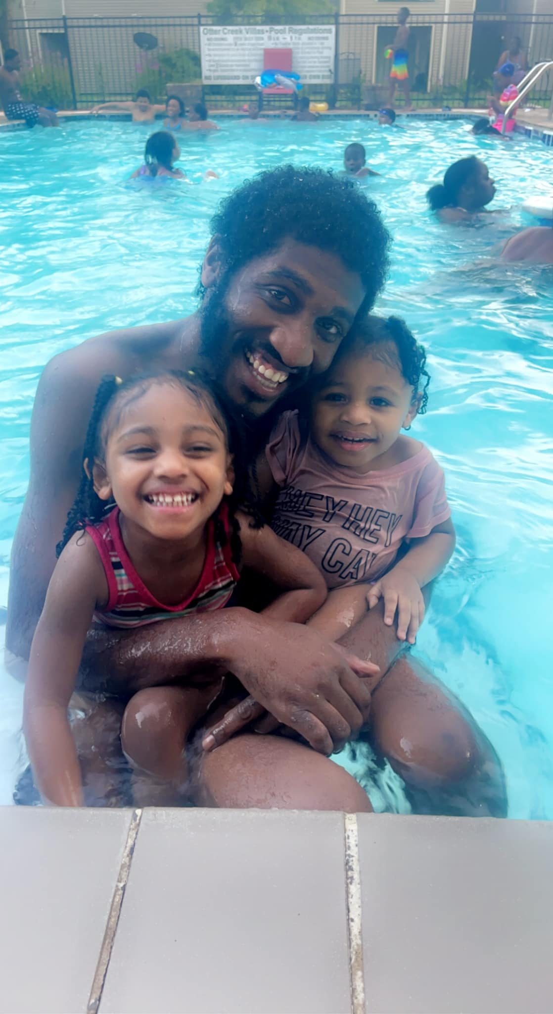 Devonte Gardner with his two daughters in a swimming pool.