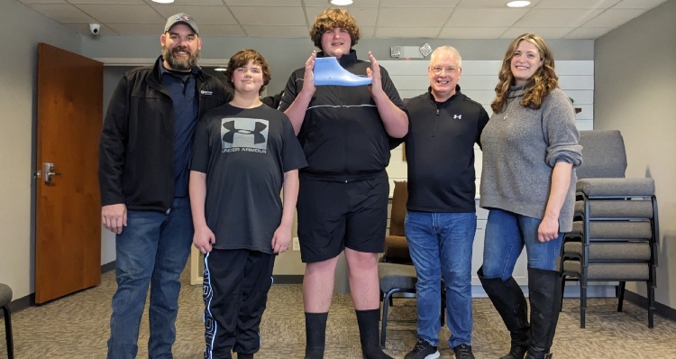 Eric Kilburn Jr and his family with new shoe