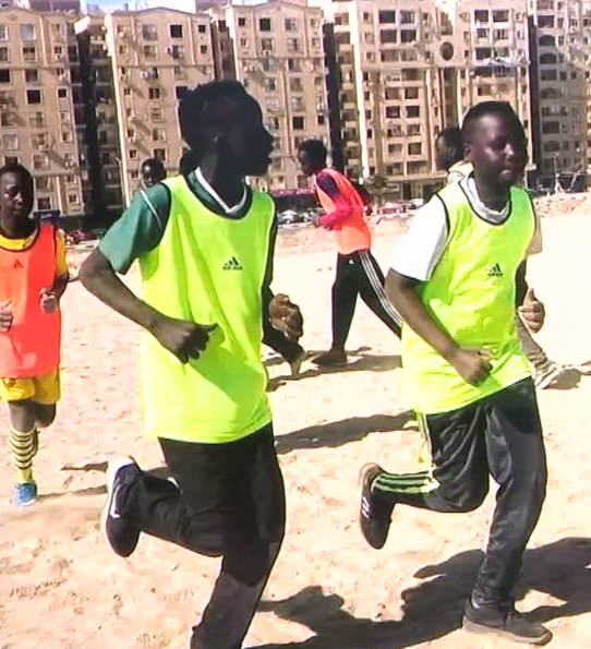 MJ running and playing soccer with a friend in Egypt