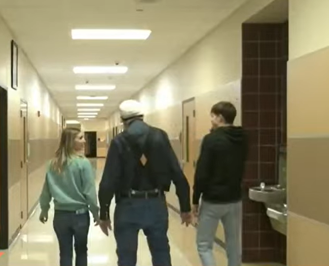Mr. James walking with 2 students