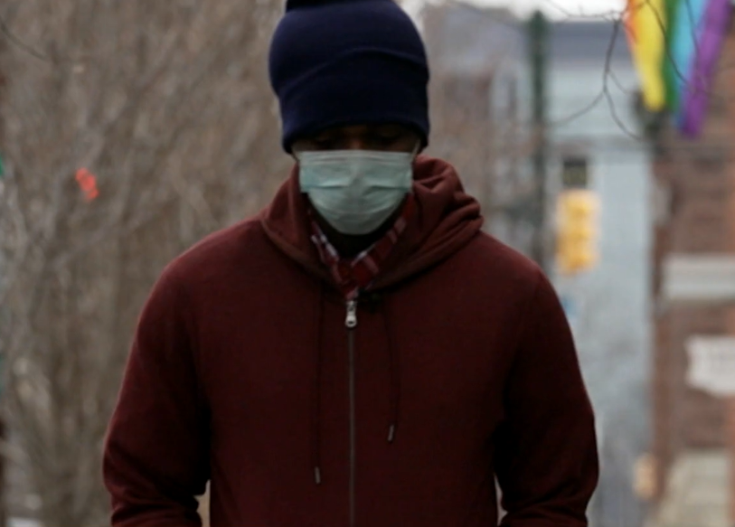Rashawn Turner walking with a face mask on.