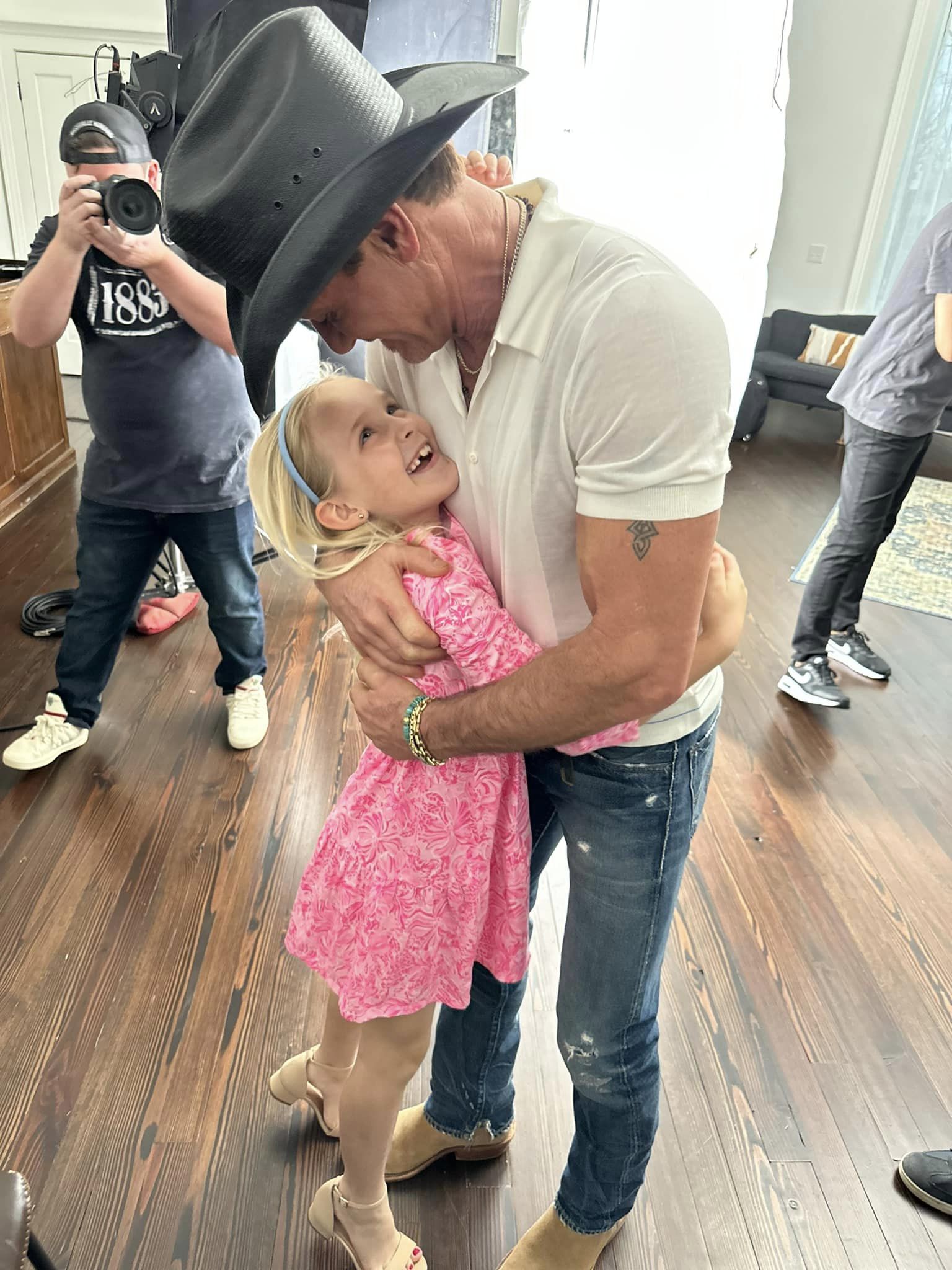 Tim McGraw dancing with Michael Hugo's daughter.