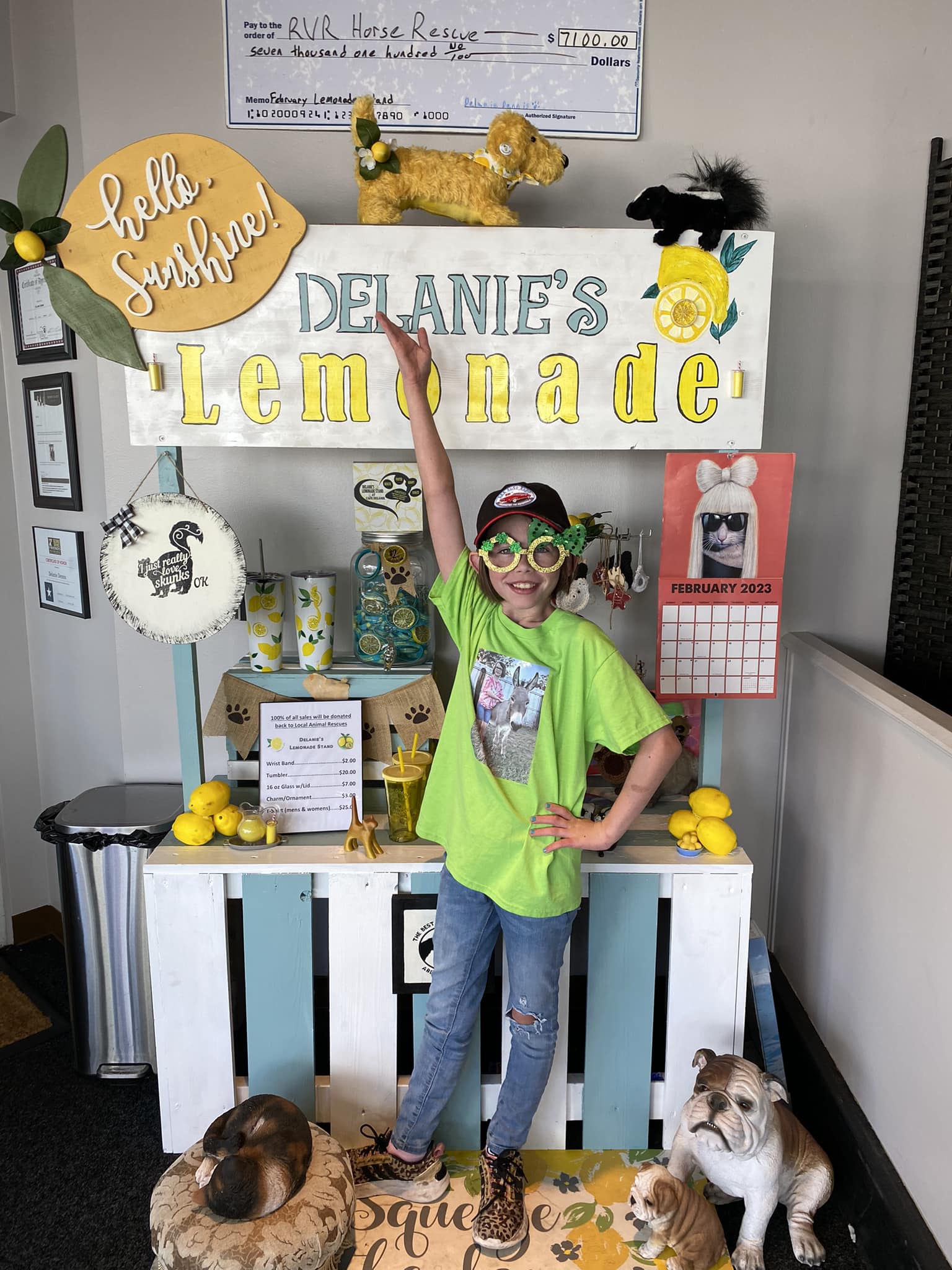 Delanie Dennis standing by her lemonade stand.