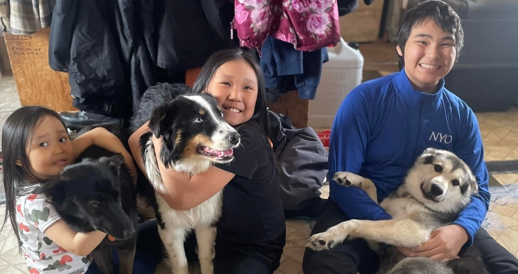 Iworrigan kids hug their three dogs