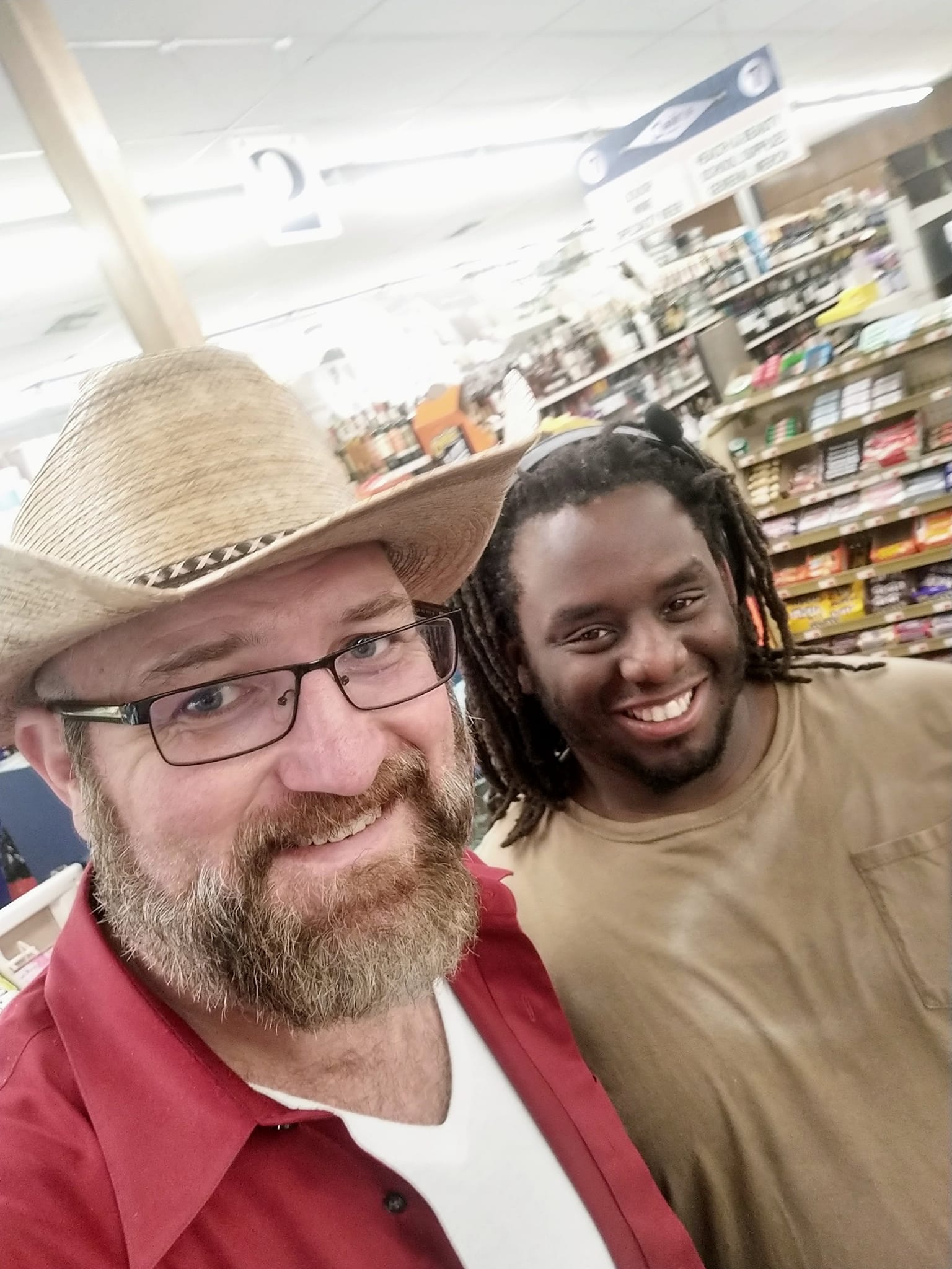 Jason Boudreaux and Kevin Jones take a selfie in the grocery store.