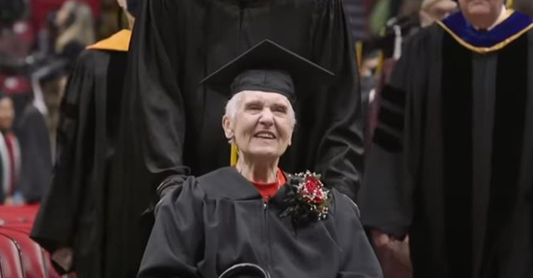 joyce in her cap and gown at commencement, smiling in joy