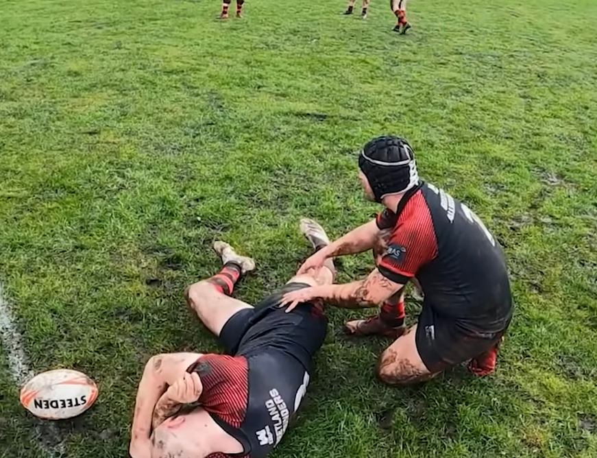 Chris Robinson fakes an injury during a rugby game.