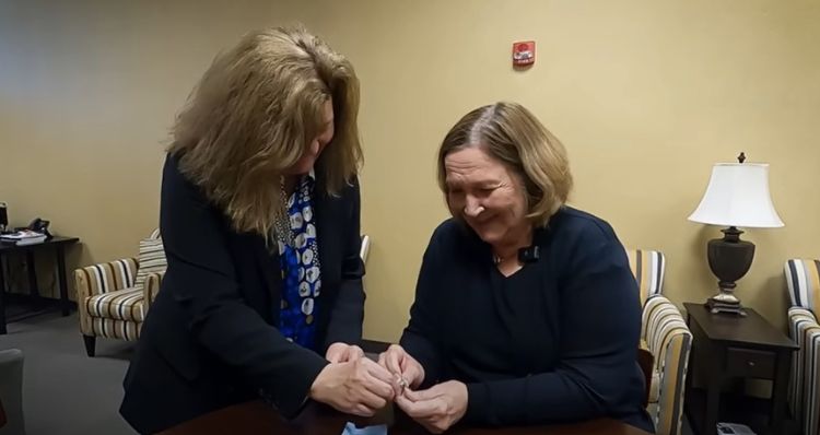Mary Strand is reunited with her missing ring at the Met Council office.
