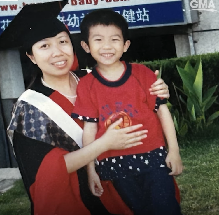 Wenjing Cao wearing a graduation cap and gown with her young son Hefei Liu.