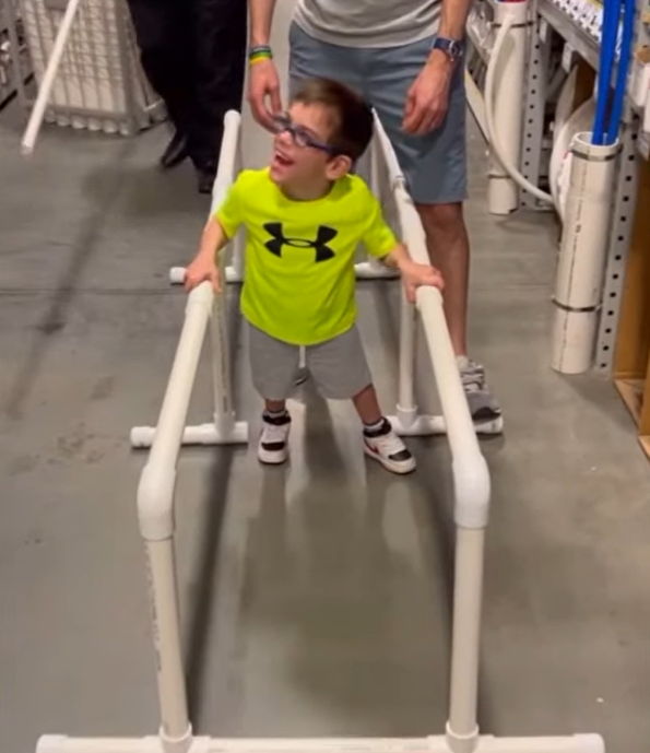William Getty tries out pvc pipe parallel bars at Lowes