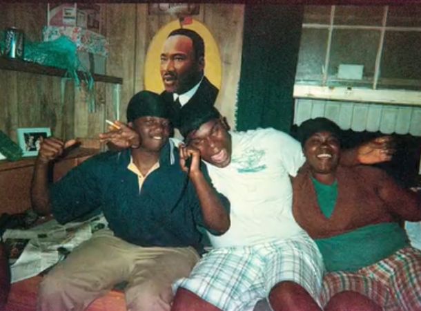 A loving family celebrates together in a vintage photo from a disposable camera.