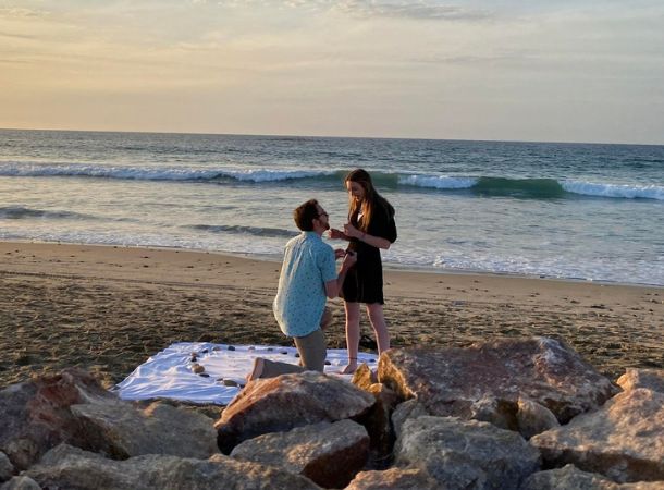 Tyler West proposes to Kelsey Poll on the beach. 