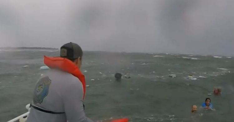 Travis Brady helps to rescue people from the capsized boat.