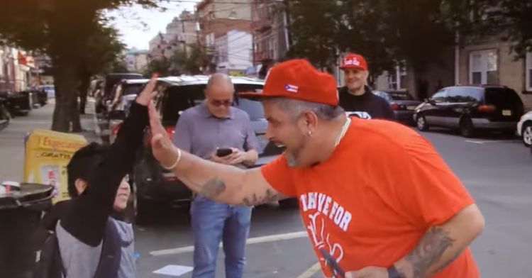 Eddie Pabon tries to brighten students' days with high-fives.