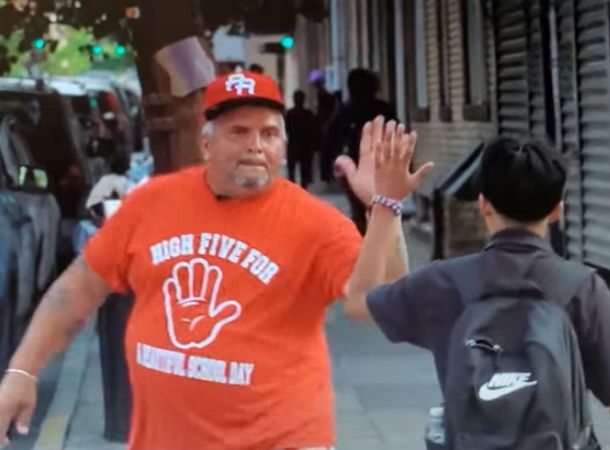 Eddie Pabon gives out high fives to students every morning.