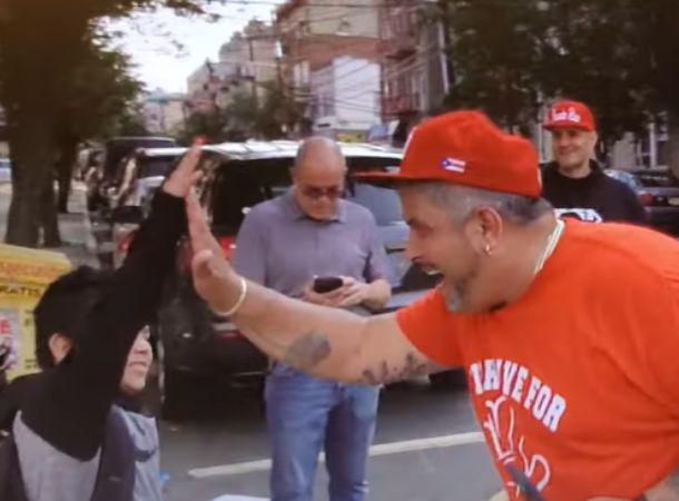 Eddie Pabon tries to brighten students' days with high-fives.