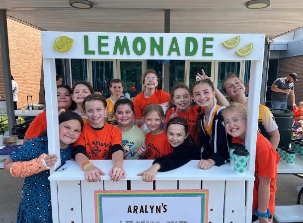 Aralyn and her friends set up a lemonade stand.