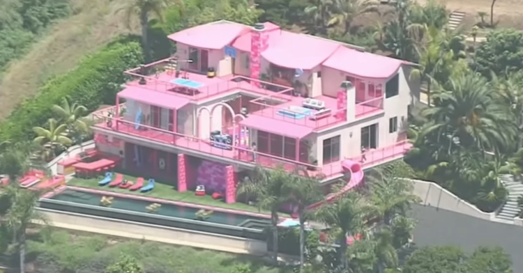 Aerial view of the large and very pink mansion that is the real-life Barbie Malibu Dreamhouse that's available through Airbnb.