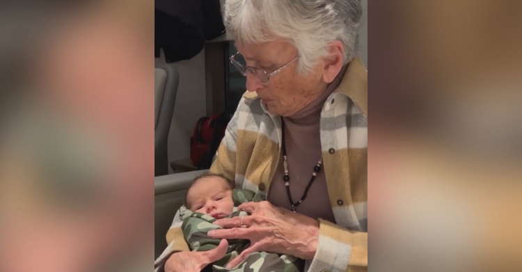 Great grandma holds her newest great grandson in her arms as she sings "I Love You a Bushel and a Peck."