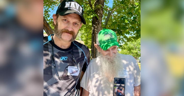 Christian Huff and Ken Huff pose for a photo outside.