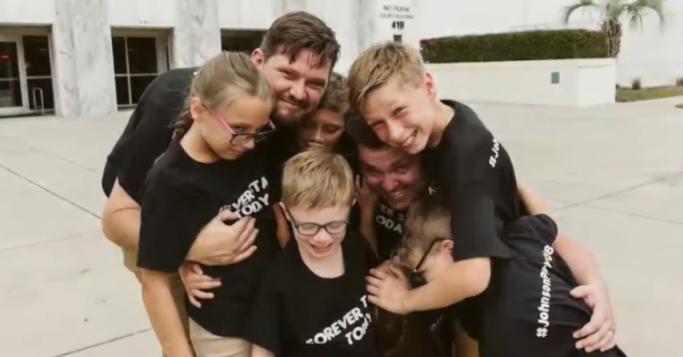 The Johnson family huddle up for a hug outside of the court house.