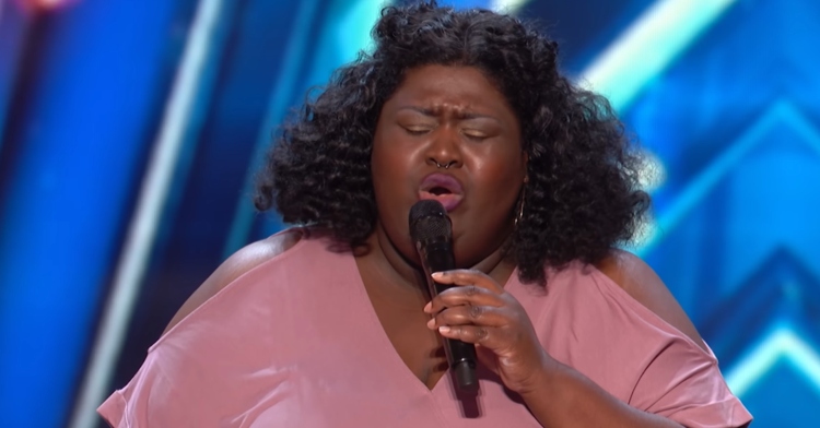 Woman named Lachuné sings with her eyes closed on the "America's Got Talent" stage.