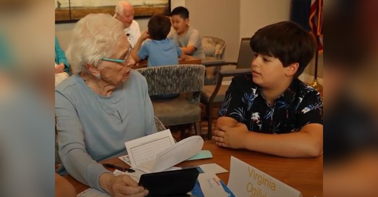 an elderly woman speaking with her pen pal, a young boy.