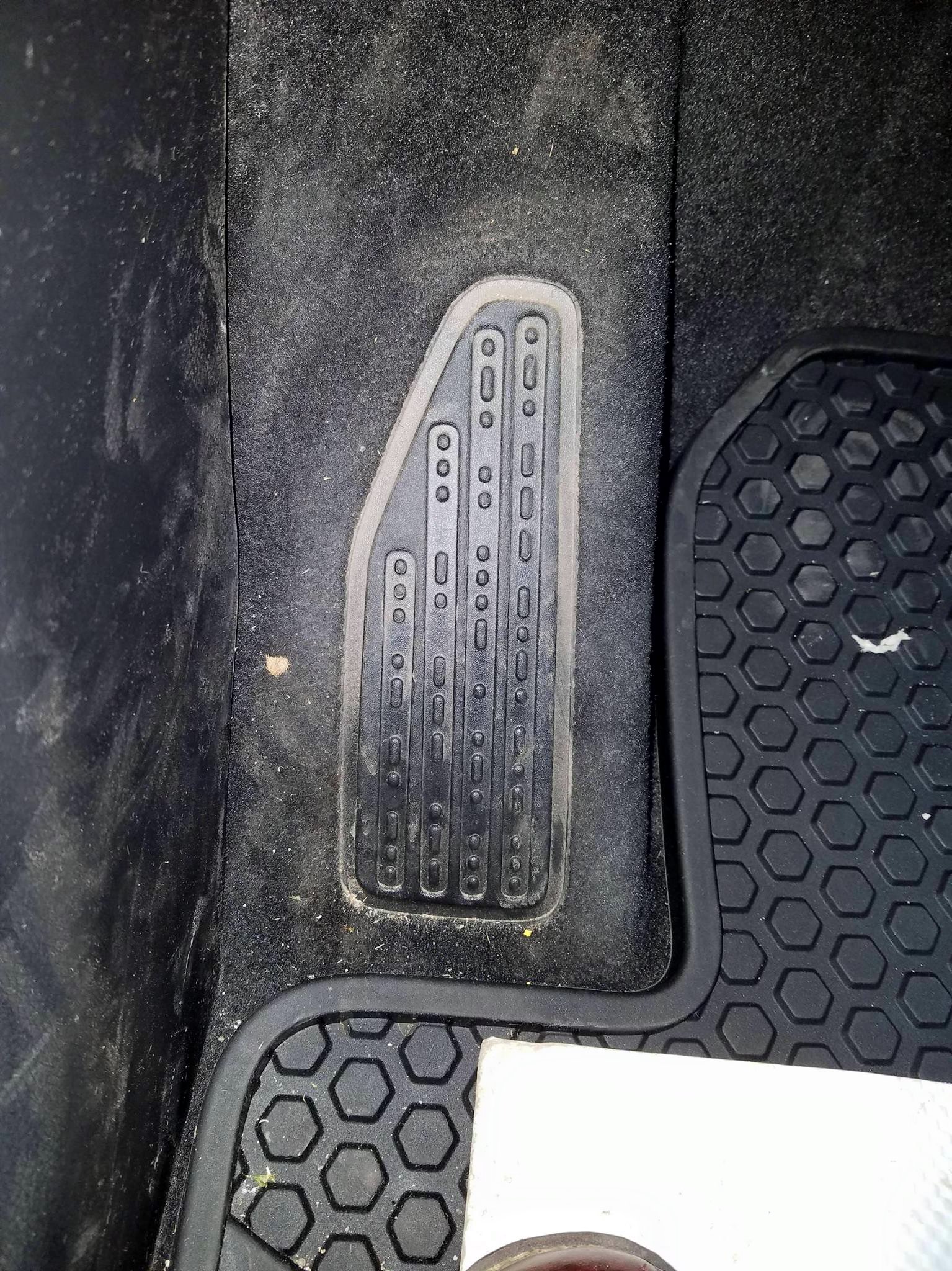 Foot rest with dots on it from a Jeep. The footrest in my new Jeep says, "sand snow rivers rocks" in Morse code