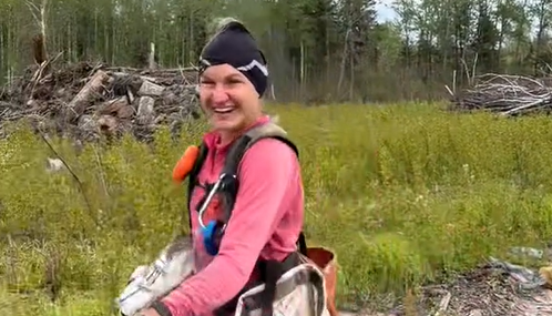 Leslie loves planting trees at her summer job.