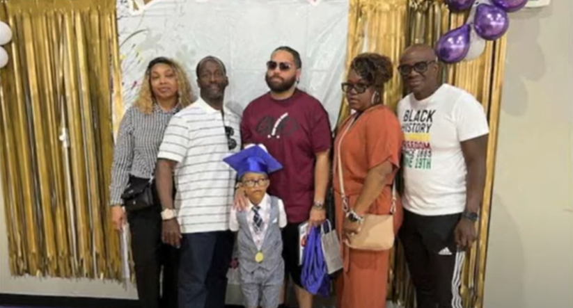 Kindergartener Jaxon Carter poses for graduation photos with his family.