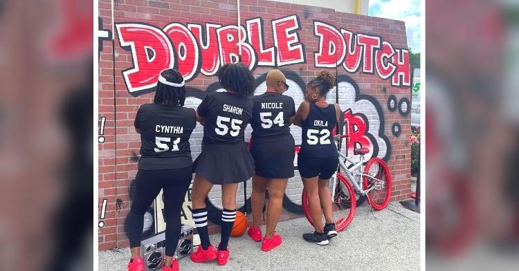 women in double dutch club pose together
