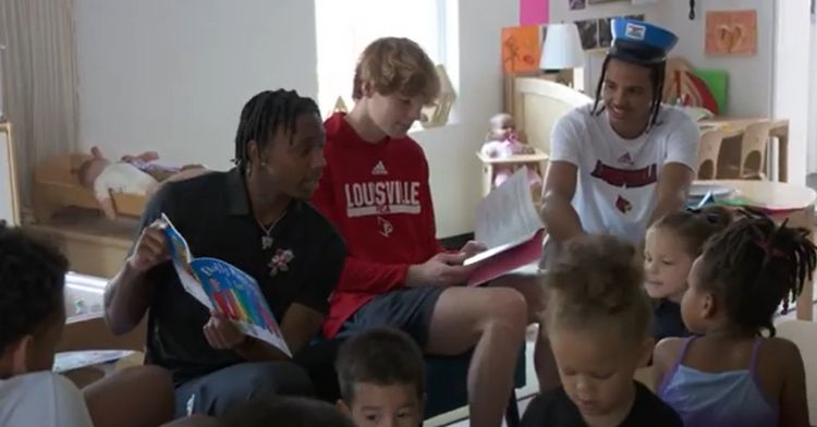 College students read books to small children.